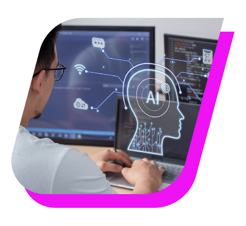 A person works at a desk with multiple computer screens displaying code. A digital overlay shows a human head icon labeled "AI," with various technology-related symbols connected to it, signifying artificial intelligence integration and breaking barriers in tech innovation. The image has a curved magenta border.